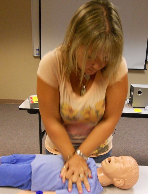 Woman Practicing CPR for Children